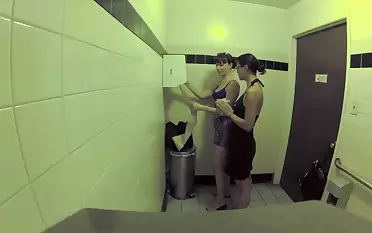 Two bitches are in lenience bathroom, licking aware of